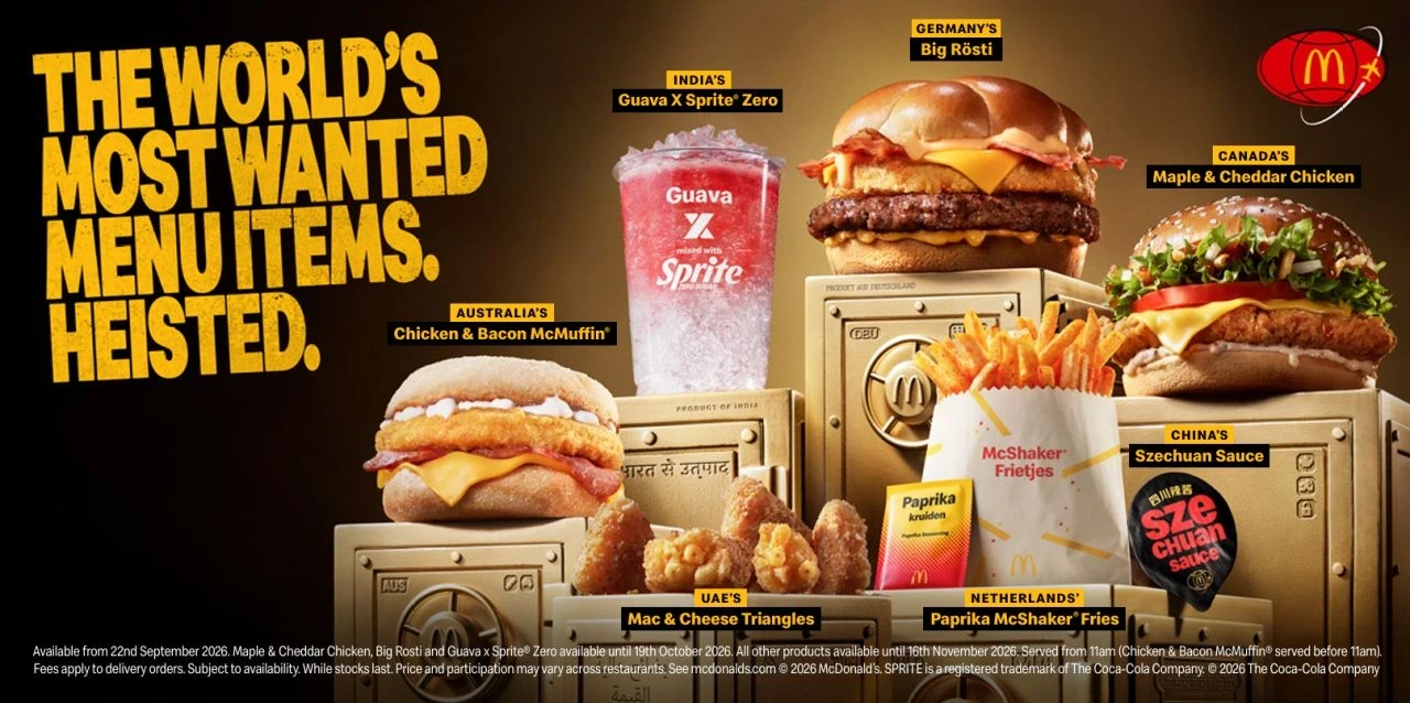 Visual principal de McDonald’s World Menu Heist con varios productos internacionales colocados sobre cajas fuertes doradas y el titular The world's most wanted menu items. Heisted.